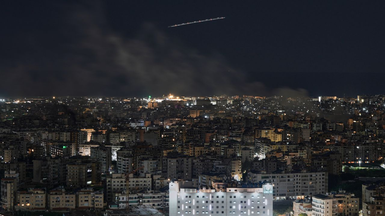 Middle East Airlines plane flies as smoke rises in Dahiyeh