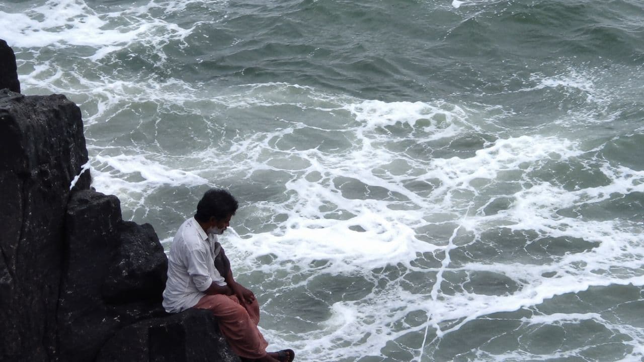 AI Generated Image of a Man Sitting on the Rock