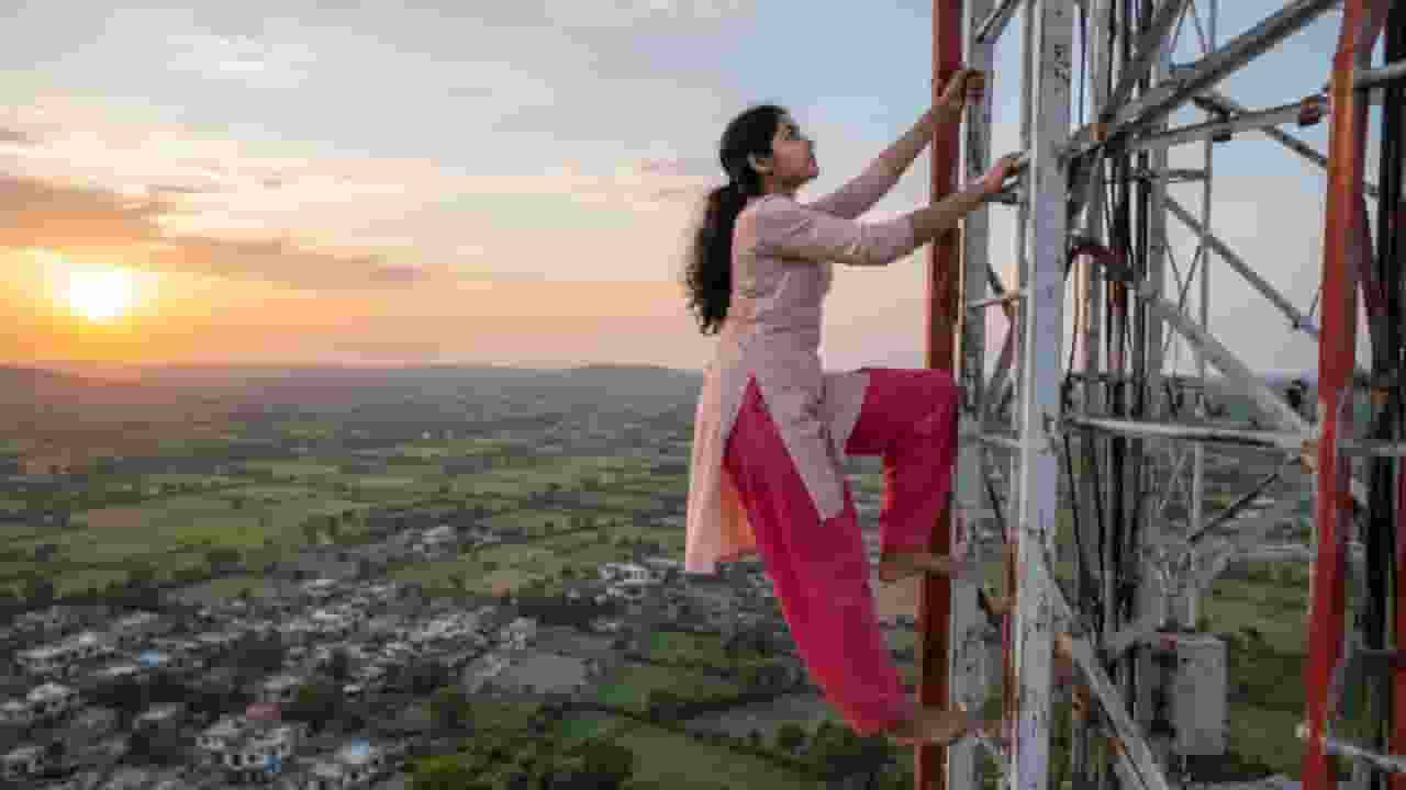 Woman climbs tower