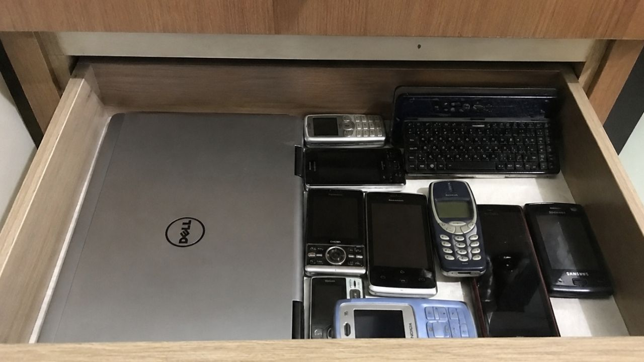 image created by chat gpt putting old phones laptop in drawer